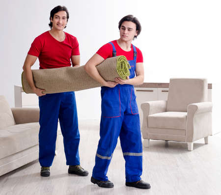 Two young contractor employees moving personal belongingsの写真素材