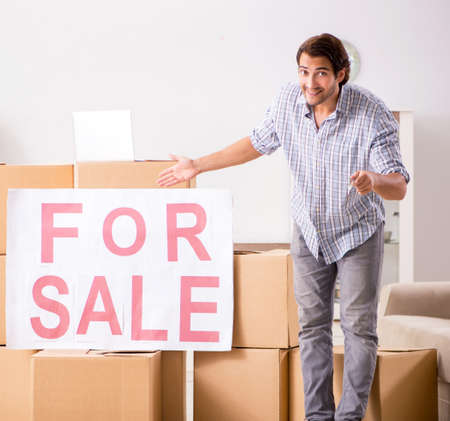 Young man offering home for sale and moving outの写真素材