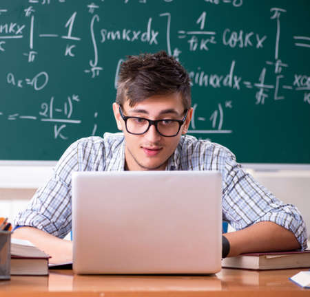 The young male student studying math at schoolの写真素材