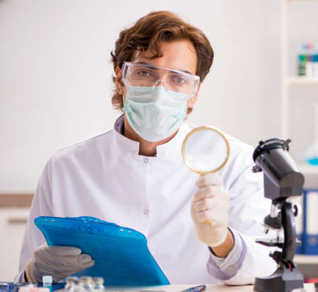 Male entomologist working in the lab on new speciesの写真素材