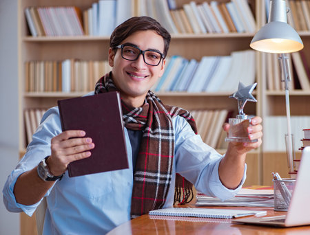 Young book writer writing in libraryの写真素材