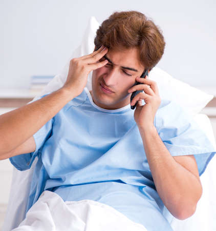 Young male patient lying on couch in hospitalの写真素材
