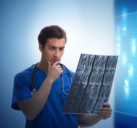 Doctor in telemedicine concept looking at x-ray imageの写真素材