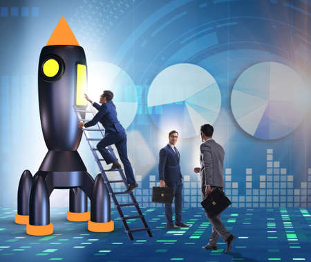 Young businessman boarding space rocket in start-up conceptの写真素材