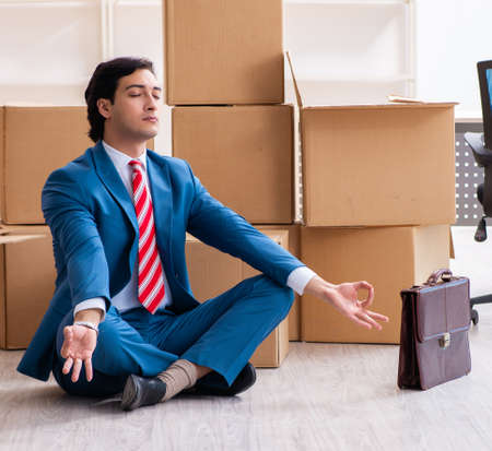 Young handsome businessman moving to new workplaceの写真素材