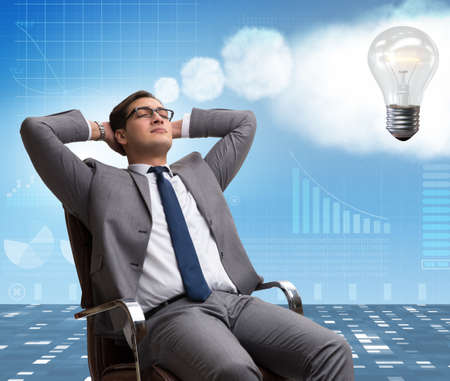 Young businessman dreaming of better thingsの写真素材