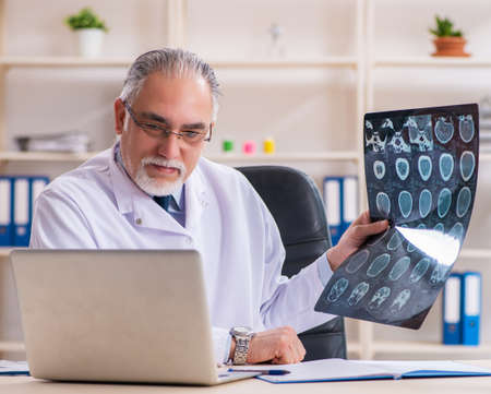 Aged male doctor radiologist in the clinicの写真素材