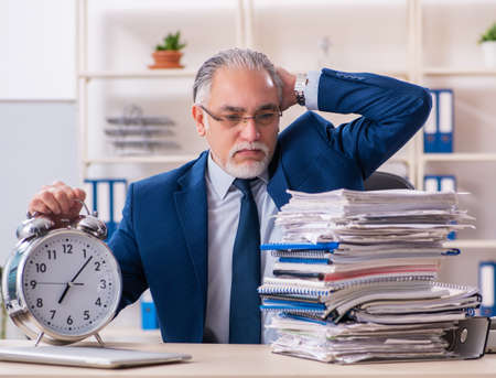 Aged male employee working in the officeの写真素材