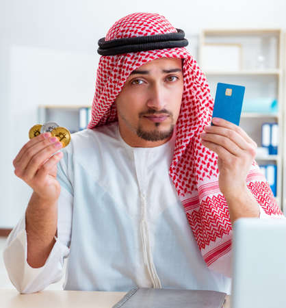 Arab man with bitcoin in cryptocurrency mining conceptの写真素材