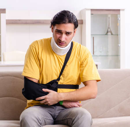 Young man after car accident suffering at homeの写真素材