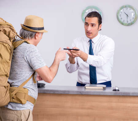 Backpacker at the hotel receptionの写真素材