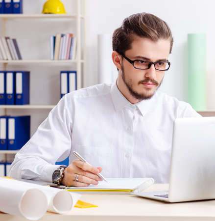 Young male architect working in the officeの写真素材