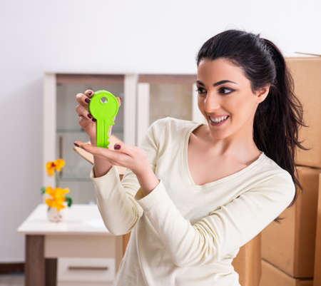 Young woman moving to new flatの写真素材