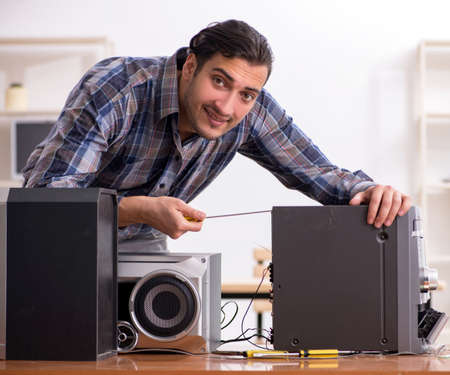 Young engineer repairing musical hi-fi systemの写真素材