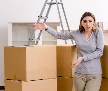 Young beautiful woman moving to new flatの写真素材