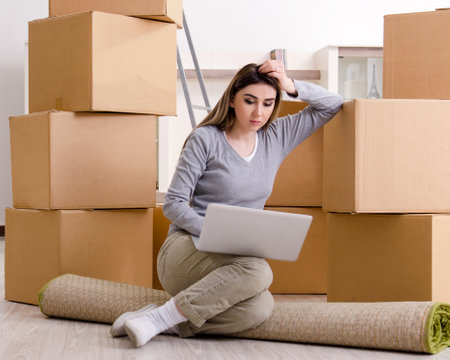 Young beautiful woman moving to new flatの写真素材