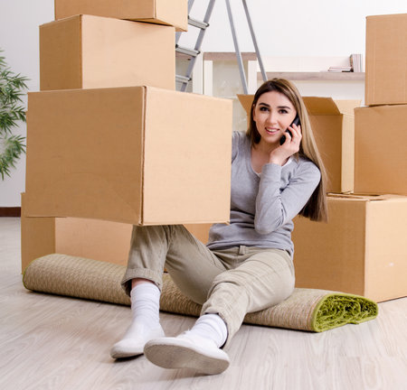 Young beautiful woman moving to new flatの写真素材