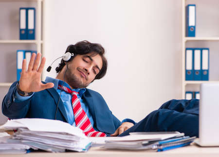 The young handsome businessman sitting in the officeの写真素材