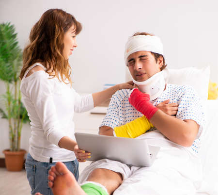 Loving wife looking after injured husbandの写真素材