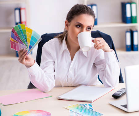 Female beautiful designer working in the officeの写真素材