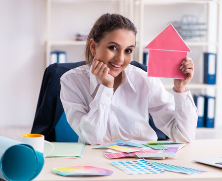 Female beautiful designer working in the officeの写真素材