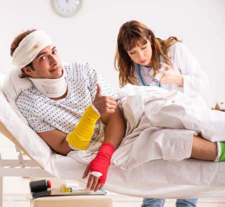 Young doctor examining injured patientの写真素材