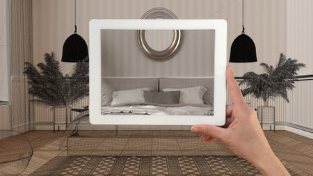 Augmented reality concept. Hand holding tablet with AR application used to simulate furniture...