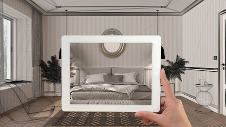 Augmented reality concept. Hand holding tablet with AR application used to simulate furniture products in custom architecture design, black ink sketch, classic bedroom with decorsの写真素材