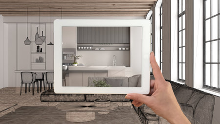 Augmented reality concept. Hand holding tablet with AR application used to simulate furniture...