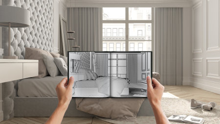 Hands holding notepad with creative bedroom design blueprint sketch or drawing. Real interior design...