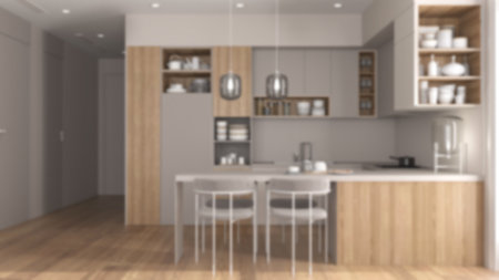 Blur background, cozy kitchen and dining room in modern apartment, table with chairs. Cabinets and shelves with potteries, pans and appliances. Parquet, interior design ideaの写真素材