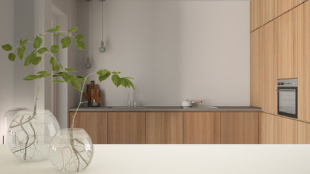 White table top or shelf with glass vase with hydroponic plant, ornament, root of plant in water,...
