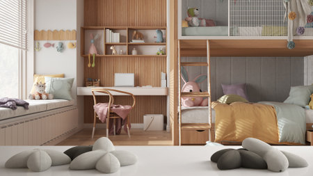 White table, desk or shelf with five soft white pillows in the shape of stars or flowers, over modern children bedroom with bunk bed, white and pastel architecture interior designの写真素材