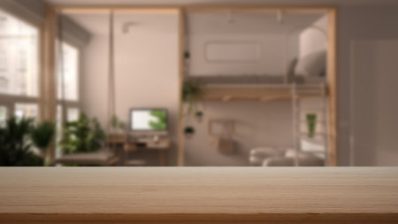 Empty wooden table, desk or shelf with blurred view of modern bedroom, bunk bed, desk and swing, modern interior design conceptの写真素材