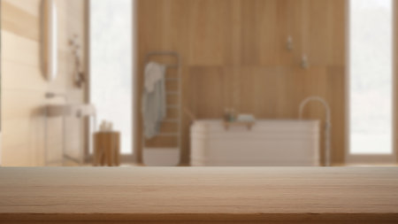 Empty wooden table, desk or shelf with blurred view of contemporary bathroom, bathtub, washbasin with mirror, towel rack, modern interior design conceptの写真素材