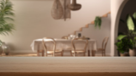 Empty wooden table, desk or shelf with blurred view of contemporary dining room, table with chairs, staircase and potted plants, modern interior design conceptの写真素材