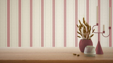 Empty interior design concept, wooden table, desk or shelf close up in red tones. Ceramic and glass vases with dry plants, straws. Striped wallpaper with copy space, templateの写真素材
