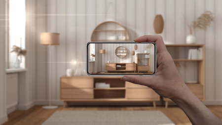 Hand holding smart phone, AR application, simulate furniture and interior design products in real...