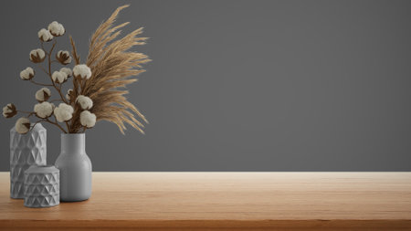 Interior design concept, wooden table, desk or shelf close up. Ceramic vases with dry plants, and cotton flowers. Gray background with copy space, template mock up ideaの写真素材