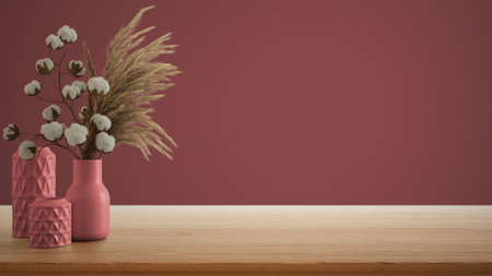 Interior design concept, wooden table, desk or shelf close up. Ceramic vases with dry plants, and cotton flowers. Red background with copy space, template mock up ideaの写真素材