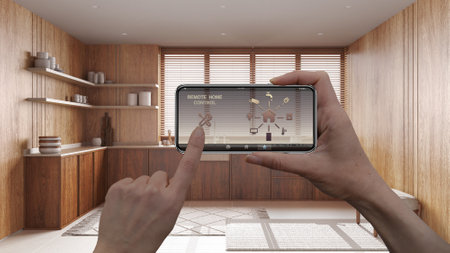 Remote home control system on a digital smart phone tablet. Device with app icons. Interior of japandi wooden kitchen in the background, architecture designの写真素材