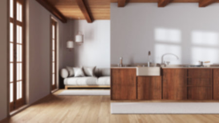 Blurred background, modern trendy kitchen and living room. Wooden cabinets and fabric sofa. Minimalist farmhouse interior designの写真素材