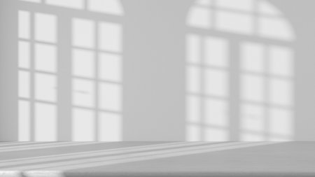 Total white project draft, wooden table with white stucco wall background with window light beam and shadow. Product presentation mock-up. Empty interior design conceptの写真素材