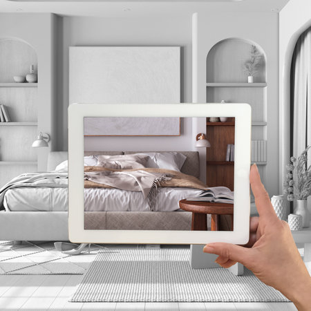 Augmented reality concept. Hand holding tablet with AR application used to simulate furniture...
