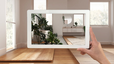 Augmented reality concept. Hand holding tablet with AR application used to simulate furniture and...