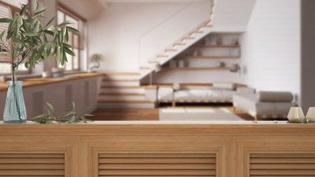 Wooden table top, cabinet, panel or shelf with shutters close up. Olive branch in vase and candles. Blurred background with minimal living room, japandi interior designの写真素材