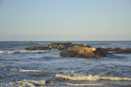 Beach with waves and rocksの写真素材