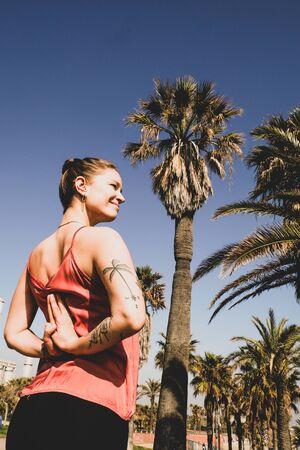 A girl doing some yoga positions and routines in different spots in Barcelona.の写真素材