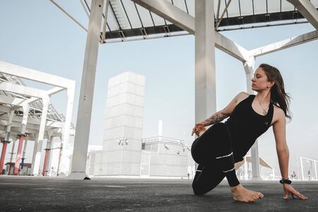 A girl doing some yoga positions and routines in different spots in Barcelona.