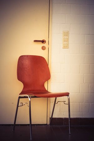 red chair in front of a doorの写真素材